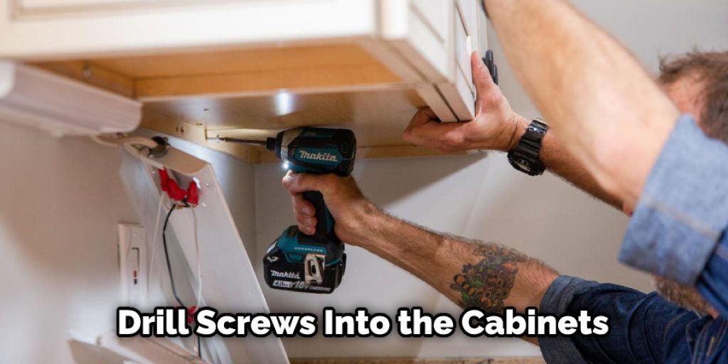 Drill Screws Into the Cabinets