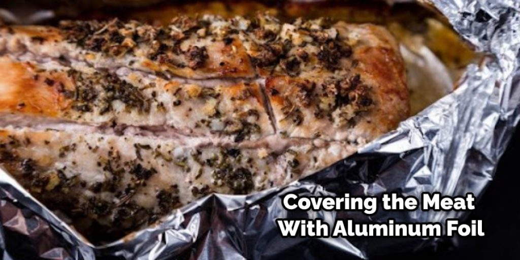 Covering the Meat With Aluminum Foil